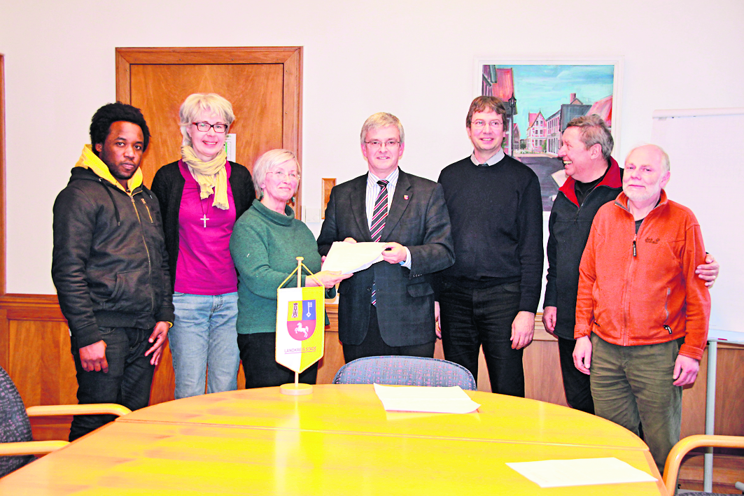 Barbara Erhardt-Gessenharter (3.v.li) übergibt gemeinsam mit anderen Vertretern der Flüchtlingsinitiativen 107 Anträge an Landrat Michael Roesberg (Mitte).