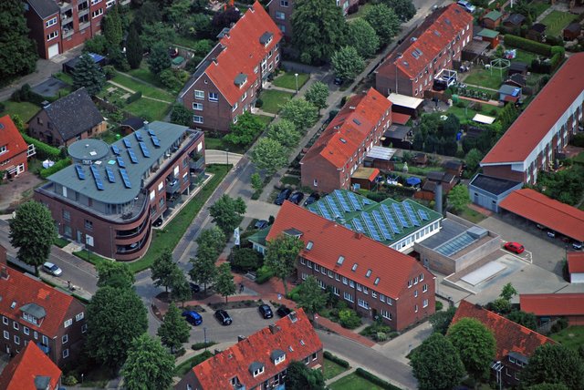 Rechts ist das Verwaltungsgebäude der Wohnstätte Stade mit Photovoltaikanlage und Holzhackschnitzelheizwerk und links das Objekt Teichstraße 49, ebenfalls mit Photovoltaikanlage, zu sehen