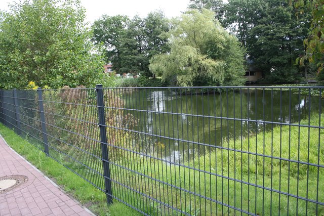 Hässlich: Jetzt wird der Teich von einem schlichten Gitterzaun eingefriedet  - wie bei einem Regenrückhaltebecken