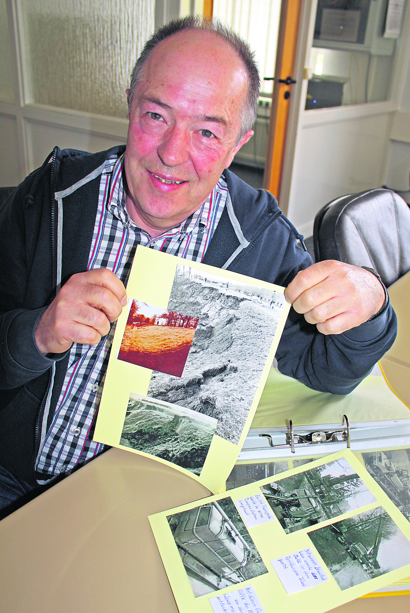 Günther Borchers zeigt ein altes Fotos vom Deichbruch in Dornbusch