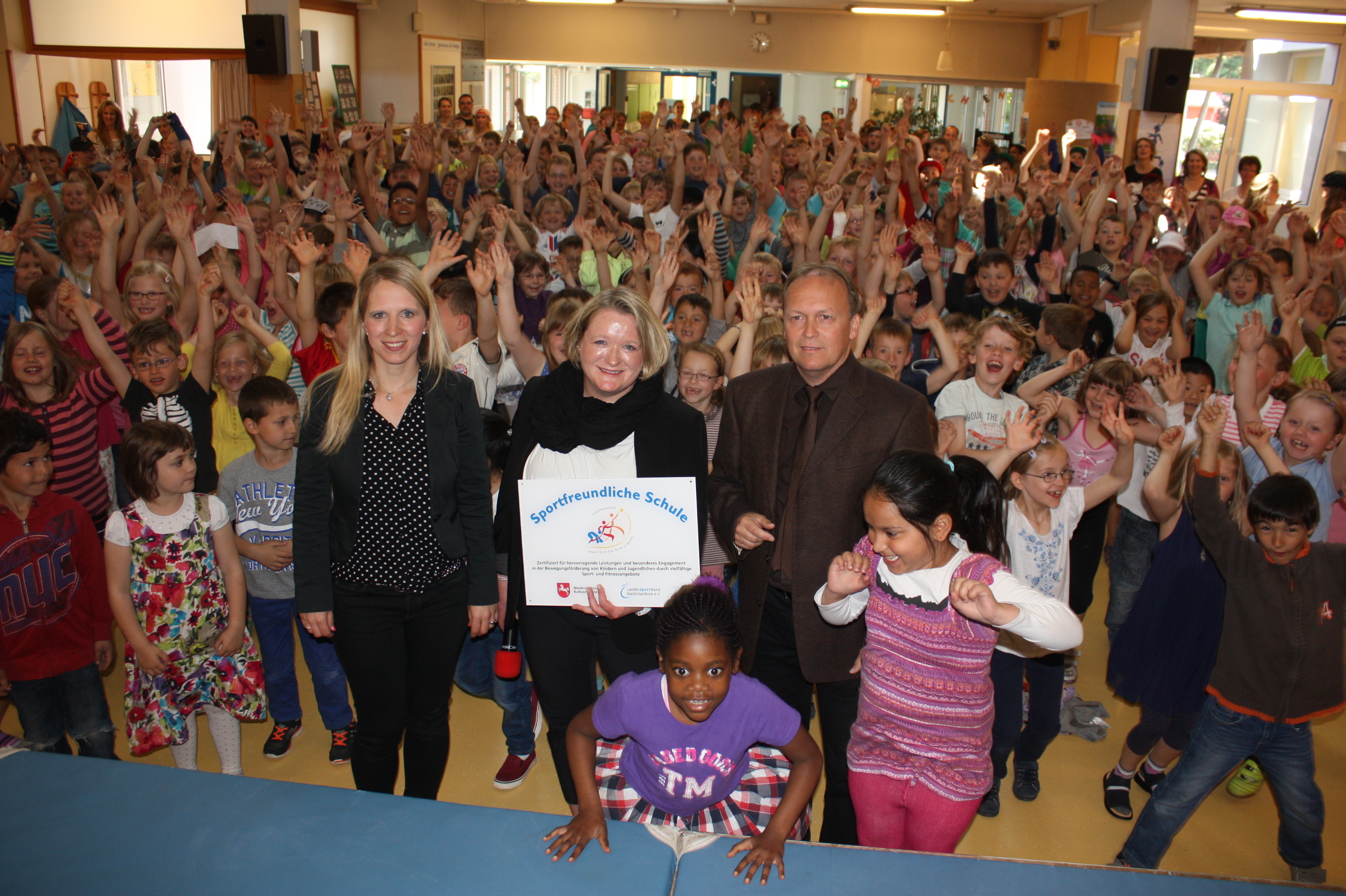 Unter dem Jubel der Wiesenschüler übergab Detlef Zeidler-Bretschneider von der Landesschulbehörde das Schild "Sportfreundliche Schule" an Katrin Bornschein (Mi.) und Katrin Schlumbohm