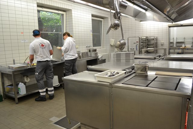 Töpfe und Bleche werden in der Küche von Hand gespült