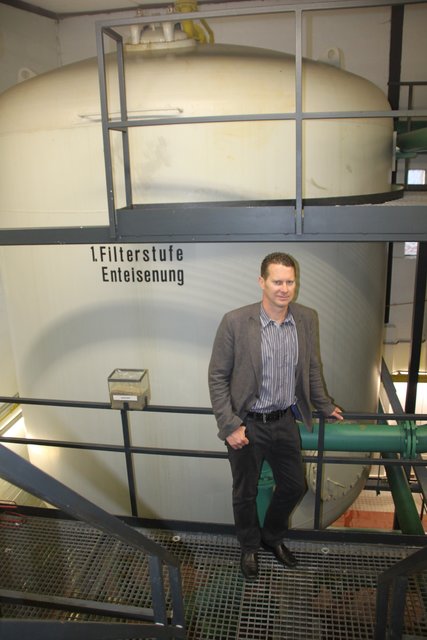 Olaf Schacht an der Enteisenungs-Anlage mit großem Filter in einem Behälter