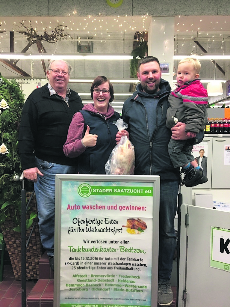 In Bützfleth gewannen Wolfgang Zemke (li.) und Sebastian Junge mit Sohn Kalle eine Ente. Es gratuliert Kathrin Schmidt vom Raiffeisen-Team