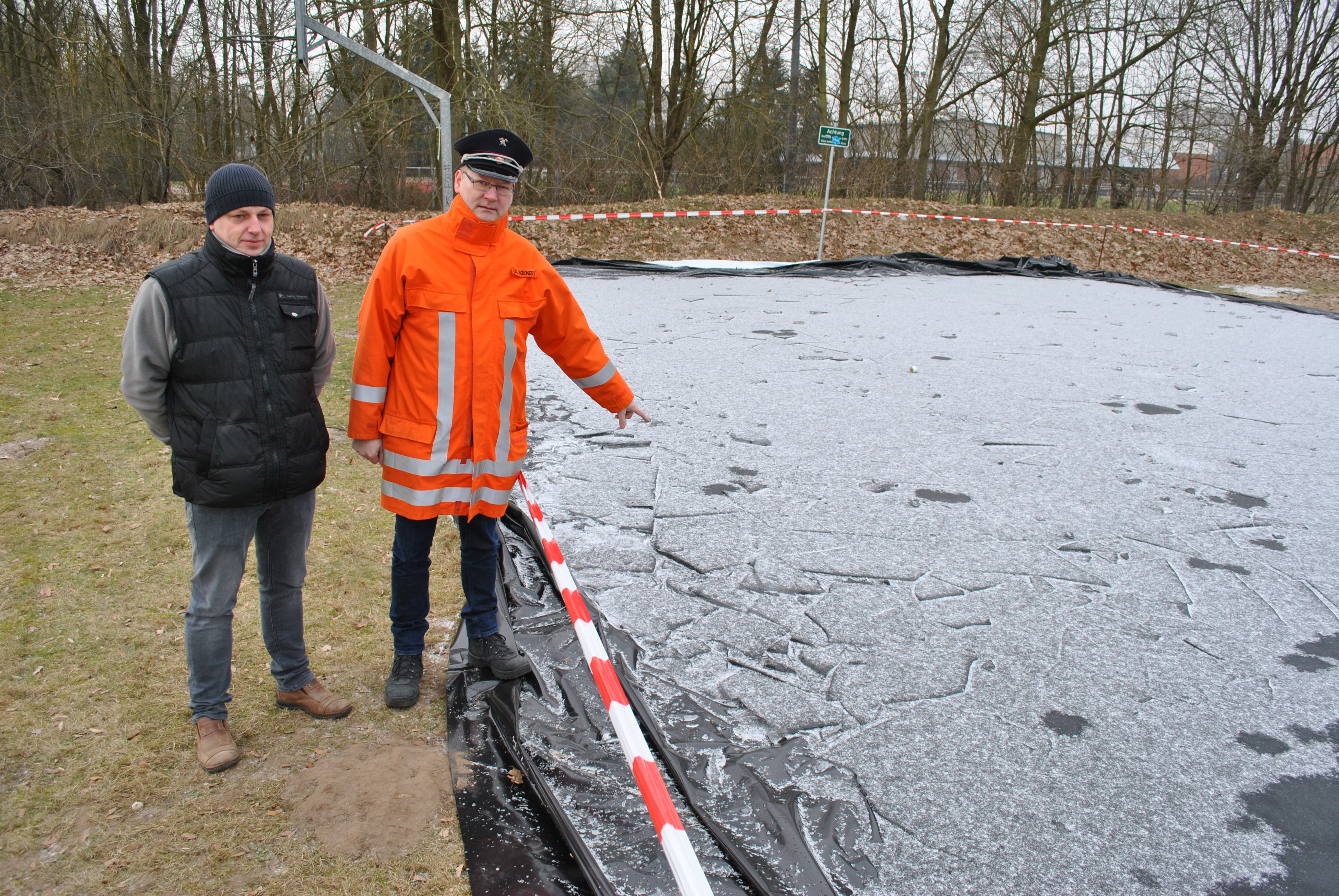 An der zerstörten Eislauffläche: Ortsbrandmeister Stephan Boenert (re.) und Feuerwehrmann Marco Beyer