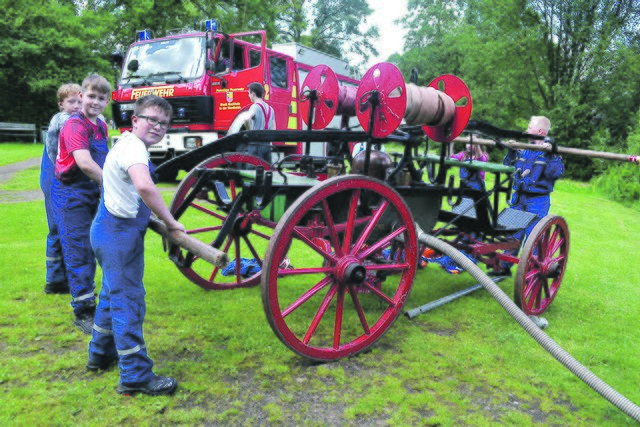 Die Jugendfeuerwehr Holm führte am Dorfteich vor, wie bei der Tragkraftspritze "Luise" noch mit Muskelkraft Wasser gepumpt werden musste