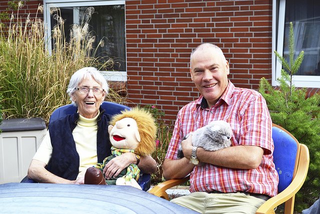 Walter Görg mit Waschbär "Willi" und eine Bewohnerin mit "Fritz" auf dem Schoß