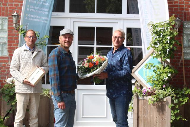 Dirk Tresenreiter (li.) und Henry Bielefeldt vom Vorstand des Gewerbevereins Rosengarten gratulieren dem langjährigen 
Mitglied Steffen Heuer | Foto: as