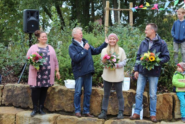 Der Vorstand des Fördervereins Jesteburger Spielplätze, Annika Sommer (v. li.), Anett Vandersee und Frank Borgstedt, hat den JestePark an die Gemeinde übergeben - Bürgermeister Udo Heitmann bedankt sich mit Blumen: "Wenn viele Hände an der gleichen Sache arbeiten, kann viel Gutes dabei herauskommen. Danke an den Förderverein! Die Kinder, die hier mit leuchtenden Augen die Spielgeräte in Benutzung nehmen - das ist es, was uns voran bringt". 