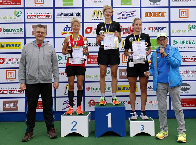Siegerehrung der 10-km-Konkurrenz: (v. li.) Cord Köster (Sparkasse Harburg-Buxtehude), Petra Herrmann, Joke Evenblij,  Christina Brockmann und Stadtlauf-Organisator Arno Reglitzky