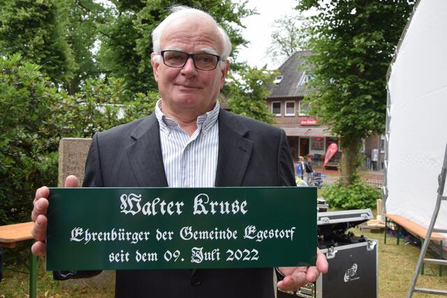 Hier wohnt ein Ehrenbürger: Walter Kruse zeigt das Schild, das unter dem Straßennamenschild an seiner Wohnstraße hängen wird | Foto: ts
