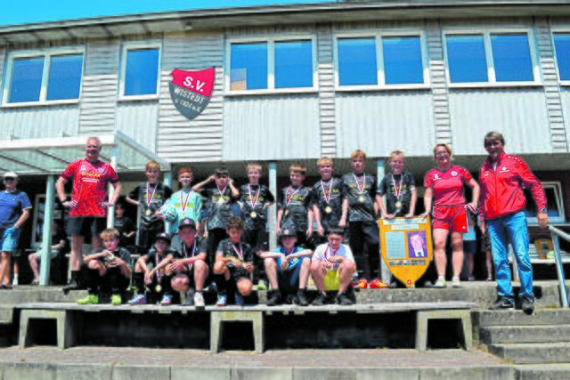 Die siegreichen U11-Junioren der JFV Ashausen-Scharmbeck-Pattensen mit ihren Trainern Bastian Schlicht (li.) sowie Andreas Kremer und Jessica Intzen (v. re.) und dem Dieter-Tomforde-Pokal Fotos: bim | Foto: bim