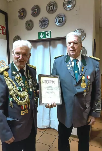 Präsident Klaus Ubert übergibt eine Urkunde an den jetzt Ehrenkommandeur Jürgen Buchholz. | Foto: KKS "Tell" Buchholz von 1930 e. V.