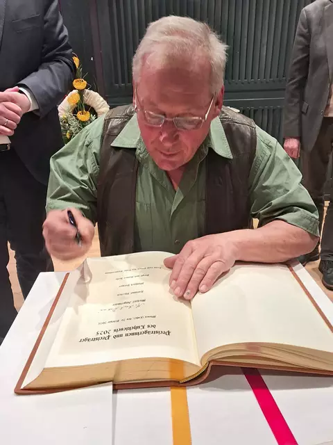 Michael Angermeier durfte sich ins goldene Buch der Stadt Winsen eintragen | Foto: Anika Werner