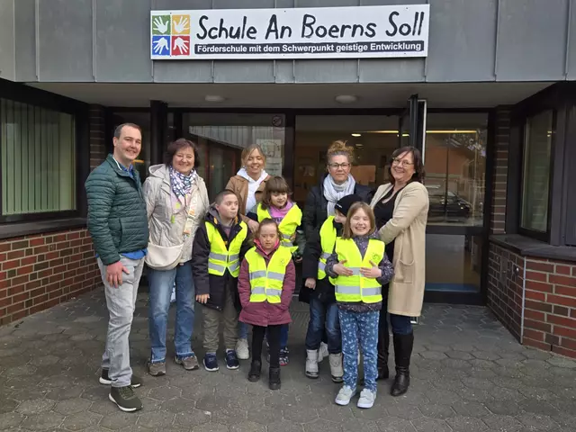 Henning Bruhn (li.) von der Buchholzer Stadtverwaltung und Ratsfrau Astrid Albers-Pestke (neben ihm) gemeinsam mit Schülern und Vertretern der Schule An Boerns Soll bei der Übergabe der Warnwesten
 | Foto: Stadt Buchholz