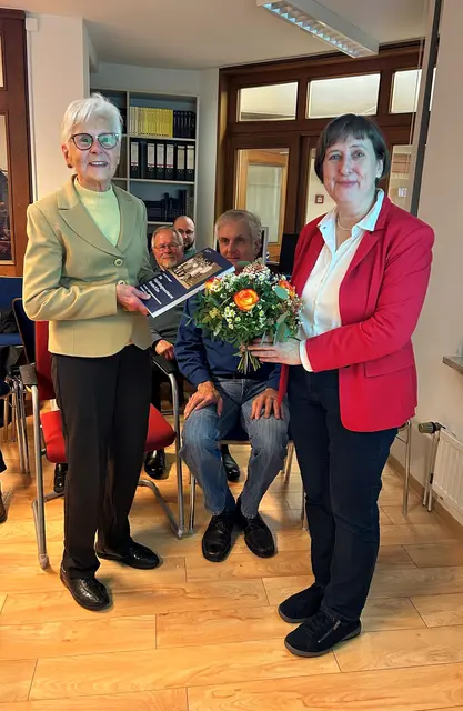 Stadtarchiv-Leiterin Dr. Christina Deggim (re.) übergibt Ursula Piepenburg Blumen und das erste Exemplar des Buches | Foto: Hansestadt Stade