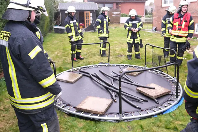 Die Feuerwehr sichert ein Trampolin mit Gehwegplatten gegen den Wind | Foto: Rolf Hillyer-Funke/Feuerwehren SG Oldendorf-Himmelpforten